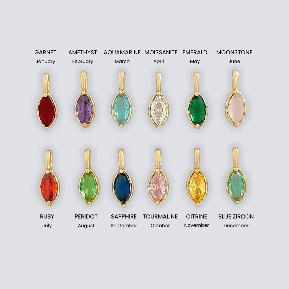 Jewelry display with gemstone pendants corresponding to each month's birthstone on a light gray background.