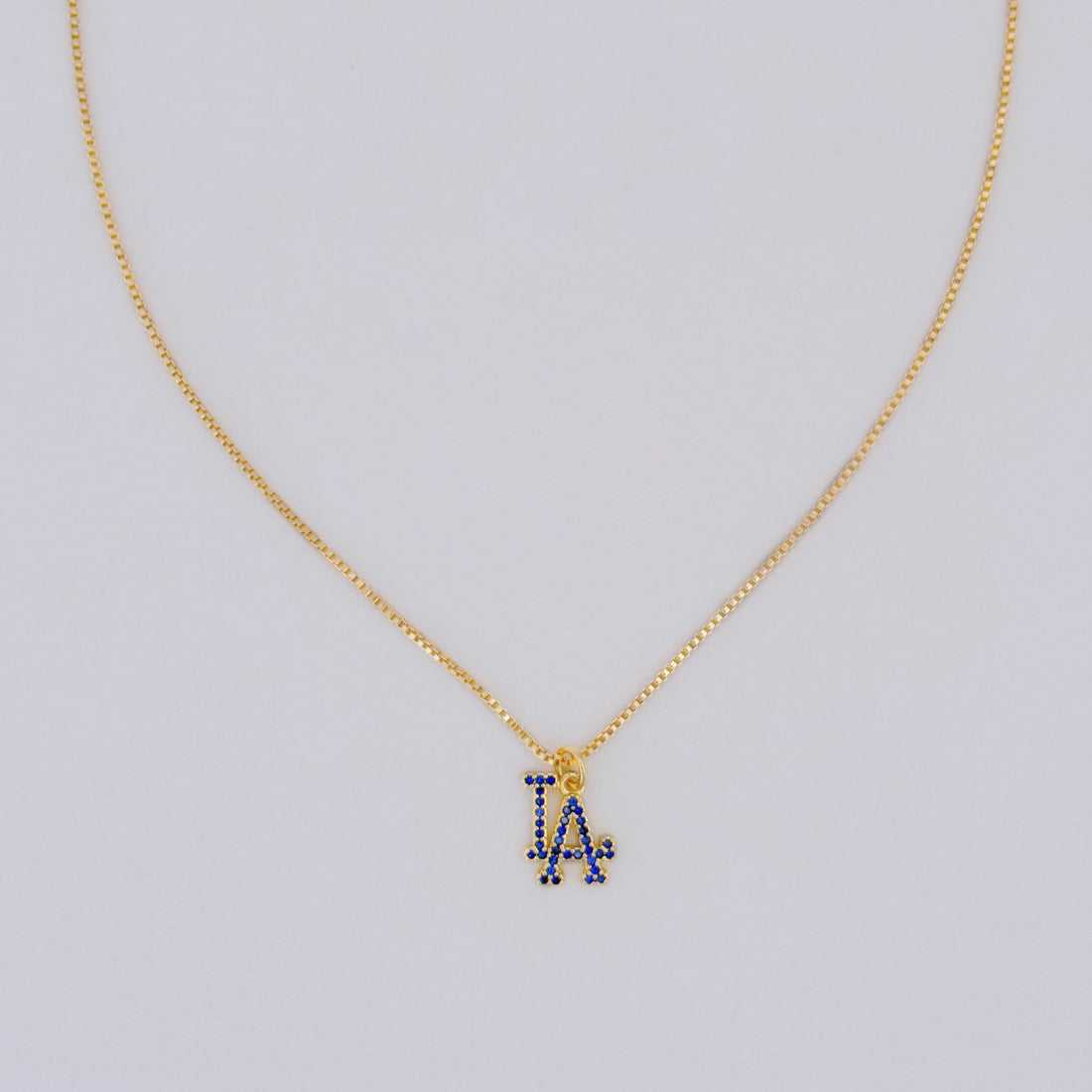 14k gold filled LA necklace with blue pavé stones on a dainty box chain, displayed on light gray background