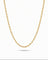 A gold paperclip chain necklace displayed in a U-shape against a clean white background with a soft shadow underneath.