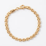 A gold-filled metal chain bracelet with a lobster clasp, photographed on a clean white background.