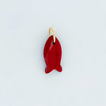 Red carnelian fish-shaped charm on a light gray background