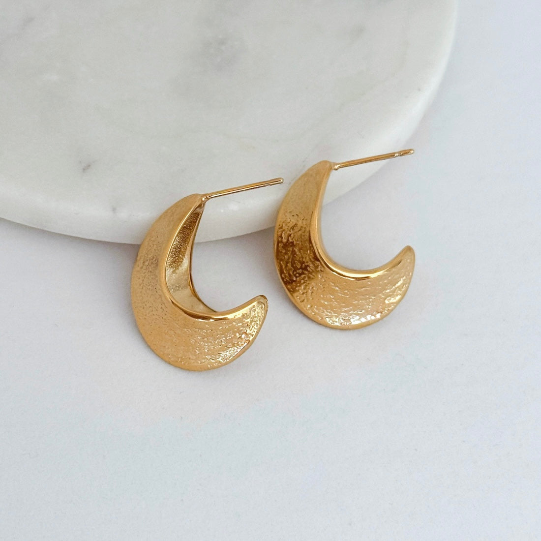 Titanium gold plated hammered open hoop earrings on white background. Waterproof hypoallergenic non tarnish jewelry by LE Sensor.