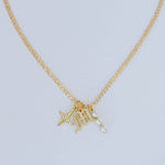 Gold-filled curb chain with three charm pendant: initial, star, and CZ dangle
