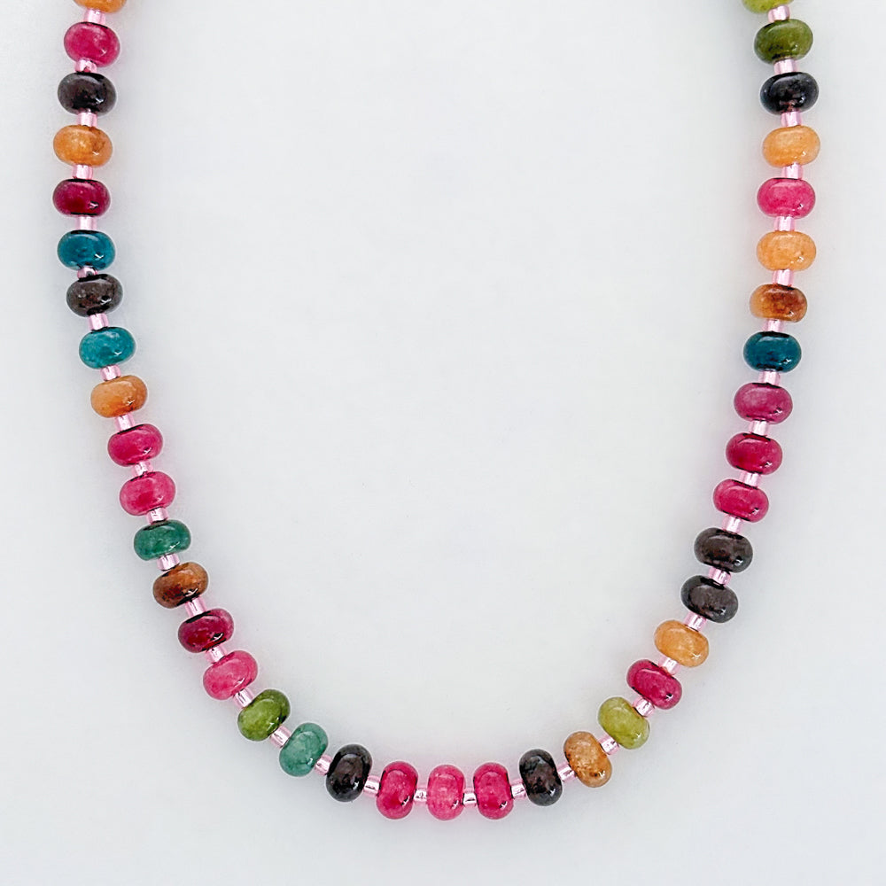 Necklace with multicolored beads on a white background