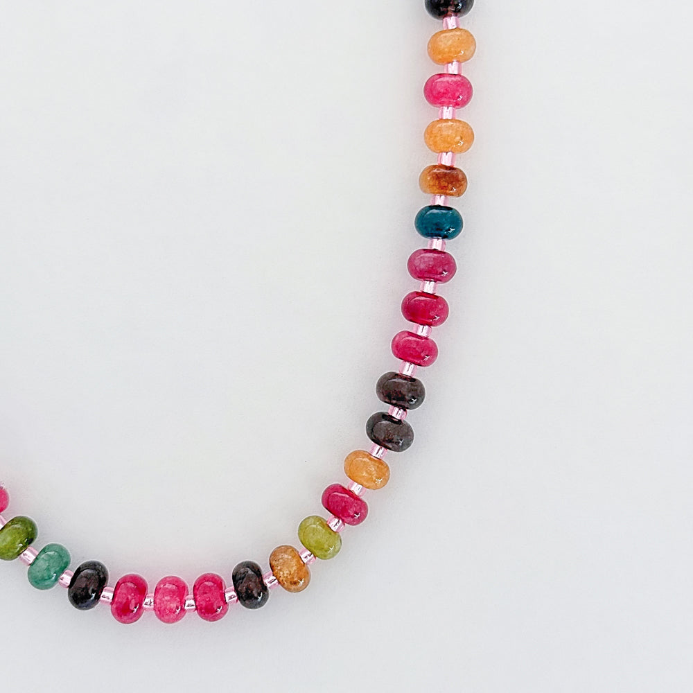 Necklace with multicolored beads on a white background