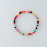 Multicolored beaded bracelet on a light gray background