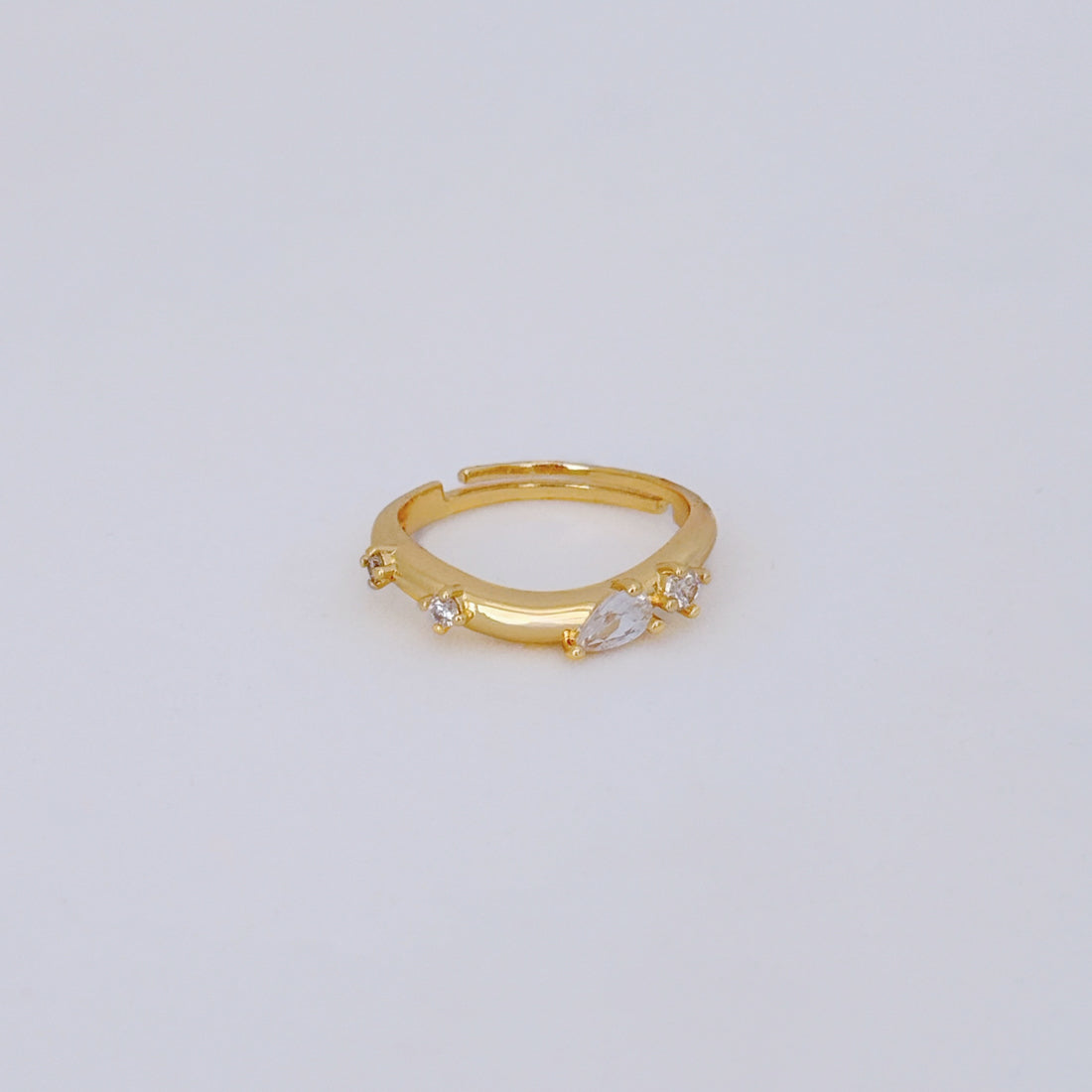 18k gold filled adjustable ring with curved band and clear CZ teardrop and round stones.
