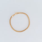 14k gold filled gold snake chain bracelet on gray background